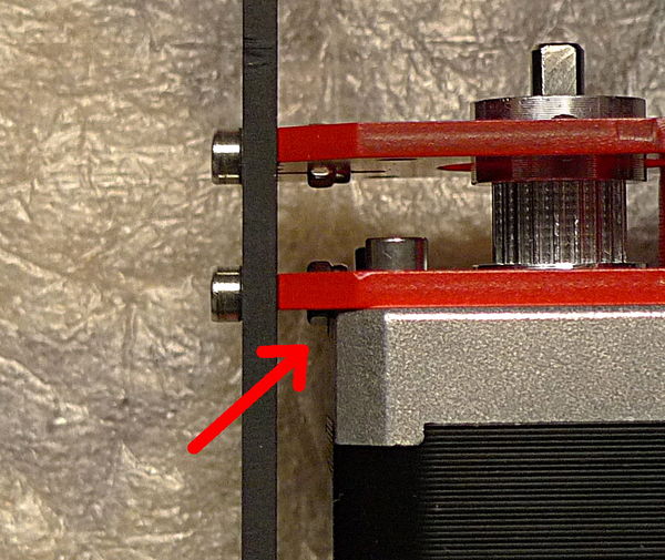 If you look carefully at where the arrow is pointing you can see the interference between the stepper and the nyloc nut, and where the stepper body has been filed away slightly.